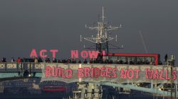 Protesters hold banner on London bridge