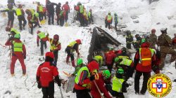 Rescue workers at Italy hotel that was covered after avalanche