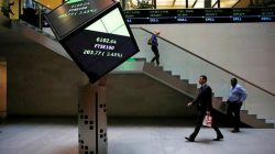 People walk through lobby of London Stock Exchange