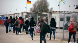 Migrants walk to Germany's customs