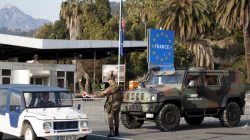 italian police officer stopping cars at border