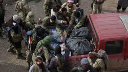 rebel fighters gather around truck carrying food