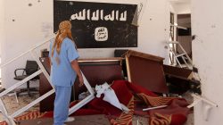 Libyan man checking building used by Islamic State