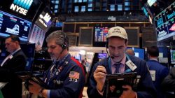Traders work on the floor at the New York Stock Exchange (NYSE) in Manhattan, New York City, U.S.