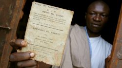 FILE PHOTO: A resident holds up a Bundu dia Kongo manifesto left behind after a police crackdown on the religious and political movement in Matadi, capital of Democratic Republic of Congo's volatile Bas Congo province, March 18, 2008.REUTERS/Joe Bavier/File Photo