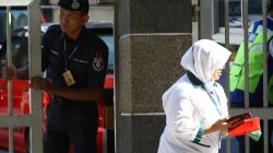 police officer looks at hospital staff