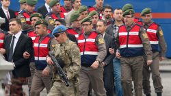 Turkish soldiers accused of attempting to assassinate President Tayyip Erdogan on the night of the failed last year's July 15 coup, are escorted by gendarmes as they arrive for the first hearing of the trial in Mugla, Turkey,