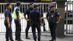 Malaysian police officers gather in front of the gate of the morgue at Kuala Lumpur General Hospital where Kim Jong Nam's body is held for autopsy in Malaysia February 21, 2017. REUTERS/Athit Perawongmetha