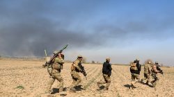 Rapid Response forces members cross farm land during a battle with Islamic State's militants south west of Mosul, Iraq February 24, 2017. REUTERS/Zohra Bensemra