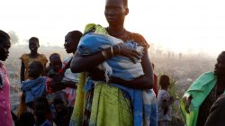 A woman waits to be registered prior to a food distribution carried out by the United Nations World Food Programme (WFP) in Thonyor, Leer state, South Sudan.