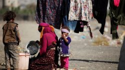 A woman sits with her children near their tent at a camp for internally displaced people in Dharawan, near the capital Sanaa, Yemen February 28, 2017. REUTERS/Khaled Abdullah