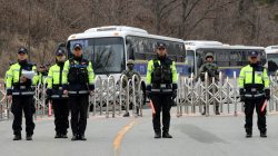South Korean policemen and soldiers stand guard at a golf course owned by Lotte, where the U.S. Terminal High Altitude Area Defense (THAAD) system will be deployed, in Seongju, South Korea, March 1, 2017. Kim Joon-beom/Yonhap via REUTERS