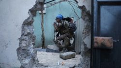 An Iraqi Special Forces soldier moves through a hole as he searches for Islamic State fighters in Mosul, Iraq.
