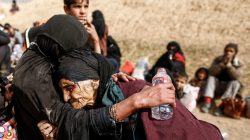 Khatla Ali Abdullah, 90, is embraced as she flees her home as Iraqi forces battle with Islamic State militants in western Mosul. REUTERS/Zohra Bensemra