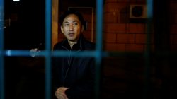 North Korean national Ri Jong Chol stands behind the fence of the North Korean embassy compound in Beijing, China, March 4, 2017. REUTERS/Thomas Peter