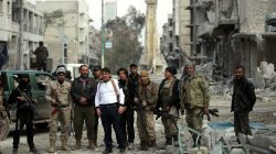 Rebel fighters pose for a picture in a damaged neighbourhood in the northern Syrian town of al-Bab, Syria March 4, 2017. REUTERS/Khalil Ashawi