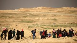 Displaced Iraqi people, who fled their homes during a battle between Iraqi forces and Islamic State militants, carry their belongings in Mosul, Iraq March 9, 2017. REUTERS/Thaier Al-Sudani