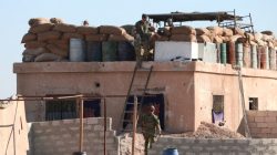 A U.S. fighter walks down a ladder from a barricade, north of Raqqa city, Syria, November 2016. REUTERS/Rodi Said
