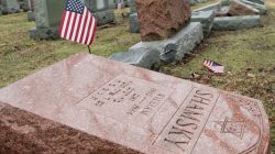 An American flag still stands next to one of over 170 toppled Jewish headstones at Chesed Shel Emeth Cemetery in University City, Missouri. REUTERS/Tom Gannam