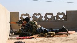 A sniper from Iraq's Federal Police force takes aim at Islamic State positions from the roof of a house on the frontline in Albu Saif, south of Mosul. REUTERS/Alaa Al-Marjani
