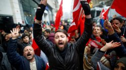 People shout slogans during a protest in front of the Dutch Consulate in Istanbul, Turkey