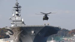 FILE PHOTO: A helicopter lands on the Izumo, Japan Maritime Self Defense Force's (JMSDF) helicopter carrier, at JMSDF Yokosuka base in Yokosuka, south of Tokyo, Japan,