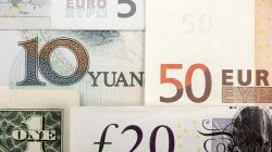 Arrangement of various world currencies including Chinese Yuan, US Dollar, Euro, British Pound,