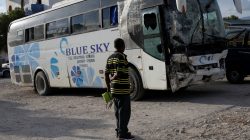 A man looks at a bus, which drove into a parade of pedestrians, parked in the police station of Gonaives, Haiti, March 12, 2017. REUTERS/Andres Martinez Casares