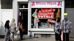 Women enter a store selling hijabs in the Brussels district of Molenbeek, Belgium, August 14, 2016. REUTERS/Francois Lenoir