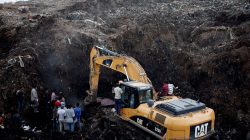 Rescue workers watch as excavators dig into a pile of garbage in search of missing people following a landslide when a mound of trash collapsed on an informal settlement at the Koshe garbage dump in Ethiopia's capital Addis Ababa. REUTERS/Tiksa Negeri