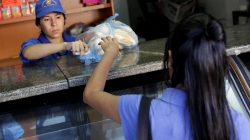A saleswoman sells bread at a bakery in Caracas, Venezuela March 17, 2017. REUTERS/Marco Bello