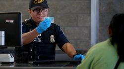 A U.S. Customs and Border Patrol officer interviews people entering the United States from Mexico at the border crossing in San Ysidro, California, U.S. on October 14, 2016. REUTERS/Mike Blake