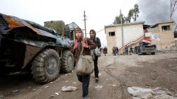 A displaced Iraqi family flees from clashes during a battle between Iraqi forces and Islamic State in Mosul, Iraq March 21, 2017. REUTERS/Youssef Boudlal