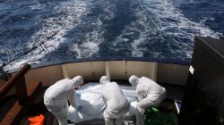 Lifeguards from the Spanish NGO Proactiva Open Arms sanitise five dead bodies of migrants on-board the former fishing trawler Golfo Azzurro following a search and rescue operation in central Mediterranean Sea off the Libyan coast, March 24, 2017. REUTERS/Yannis Behrakis