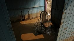 A chair stands in mud at the home of Francisco Coca after rivers breached their banks due to torrential rains, causing flooding and widespread destruction in Carapongo Huachipa, Lima, Peru