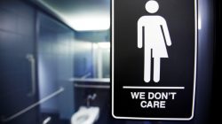 FILE PHOTO: A sign protesting a recent North Carolina law restricting transgender bathroom access adorns the bathroom stalls at the 21C Museum Hotel in Durham, North Carolina May 3, 2016. REUTERS/Jonathan Drake/File Photo