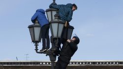 A riot police officer climbs on a lamp pole to detain opposition supporters during a rally in Moscow, Russia March 26, 2017. REUTERS/Sergei Karpukhin