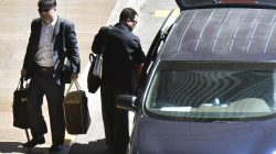 Hyon Kwang Song (R), the second secretary at the North Korean embassy in Kuala Lumpur, and Kim Uk Il, a North Korean state airline employee, arrive in Beijing intentional airport to board a flight returning to North Korea, in Beijing. Kyodo via REUTERS