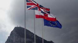 The Union Jack (L), the Gibraltarian flag (C) and the European Union flag are seen flying, at the border of Gibraltar with Spain, in front of the Rock in the British overseas territory of Gibraltar, historically claimed by Spain April 3, 2017. REUTERS/Jon Nazca