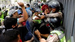 Demonstrators scuffle with security forces during an opposition rally in Caracas, Venezuela. REUTERS/Carlos Garcia Rawlins