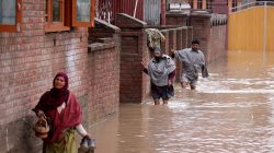 People wade through a flooded street after incessant rains in Srinagar April 7, 2017. REUTERS/Danish Ismail