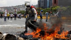 Demonstrators build a fire barricade on a street in Caracas, Venezuela