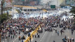 Demonstrators clash with riot police while ralling against Venezuela's President Nicolas Maduro's government in Caracas,