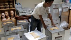 An election official prepares ballot boxes before distributing them to polling stations, in Jakarta, Indonesia April 18, 2017. REUTERS/Beawiharta
