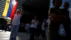 FILE PHOTO: An opposition supporter waves a Venezuelan flag during a gathering against Venezuela's President Nicolas Maduro's government in Caracas, Venezuela April 15, 2017. REUTERS/Carlos Garcia Rawlins