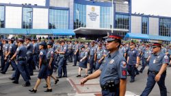 Policemen walk past Philippine National Police headquarters after taking part in the founding anniversary of the Philippine National Police celebration at Camp Crame, in Quezon city Metro Manila, Philippines February 6, 2017. REUTERS/Erik De Castro