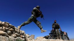 A member of Afghanistan's Special Forces unit jumps from a wall during patrol in Pandola village near the site of a U.S. bombing in the Achin district of Nangarhar, eastern Afghanistan, April 14, 2017. REUTERS/Parwiz