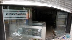 Damage is seen at the entrance of a bakery after it was looted in Caracas, Venezuela April 20, 2017. REUTERS/Christian Veron