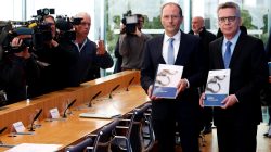 German Interior Minister Thomas de Maiziere (R) and his Saxony state counterpart Markus Ulbig present the German crime statistics for 2016 during a news conference in Berlin, Germany
