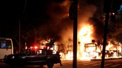 Riot police officers are seen as a bus burns during clashes between demonstrators and riot police in a protest against President Michel Temer's proposed reform of Brazil's social security system, in Rio de Janeiro, Brazil, April 28, 2017. REUTERS/Ricardo Moraes